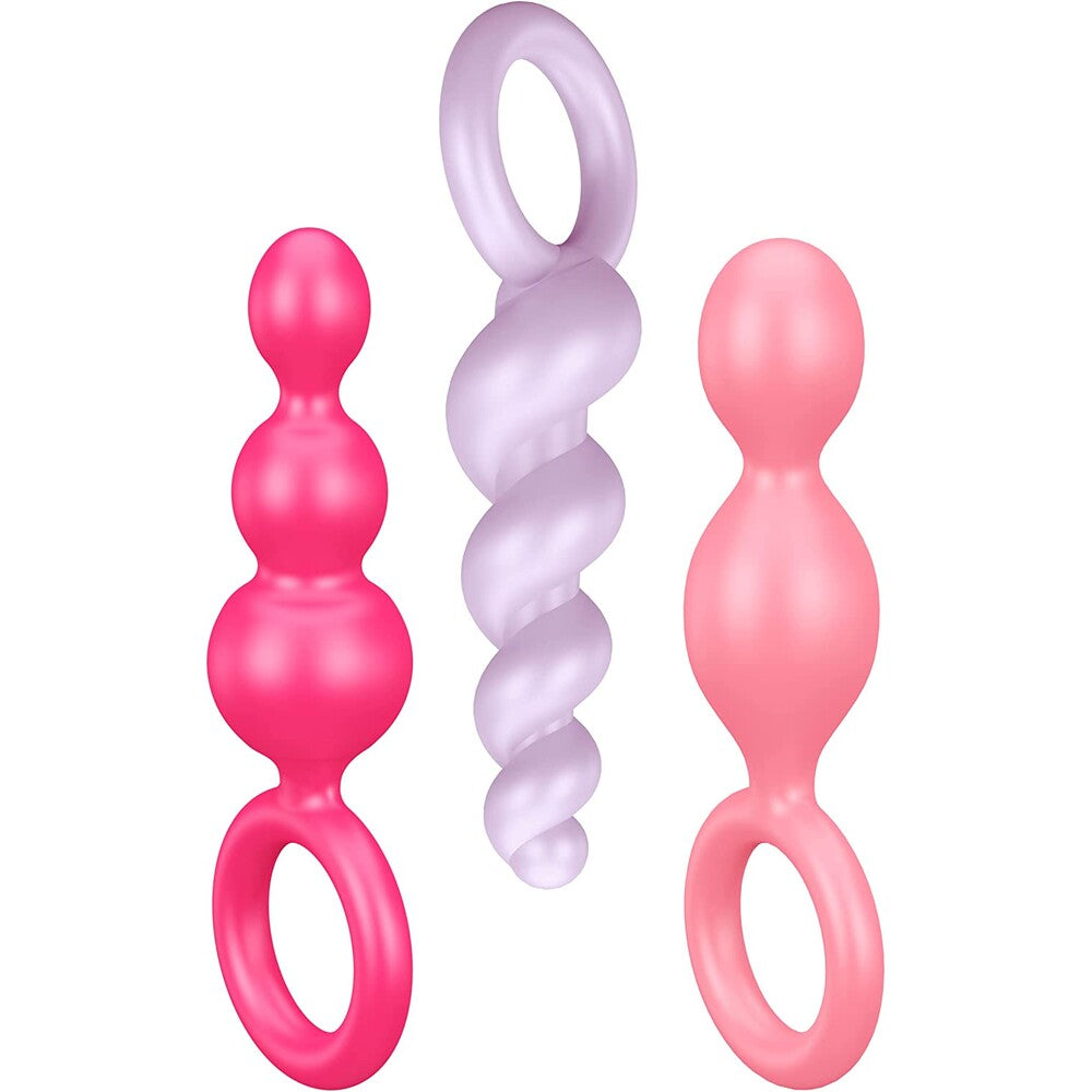 Three pink and purple silicone baby teething toys on a white background