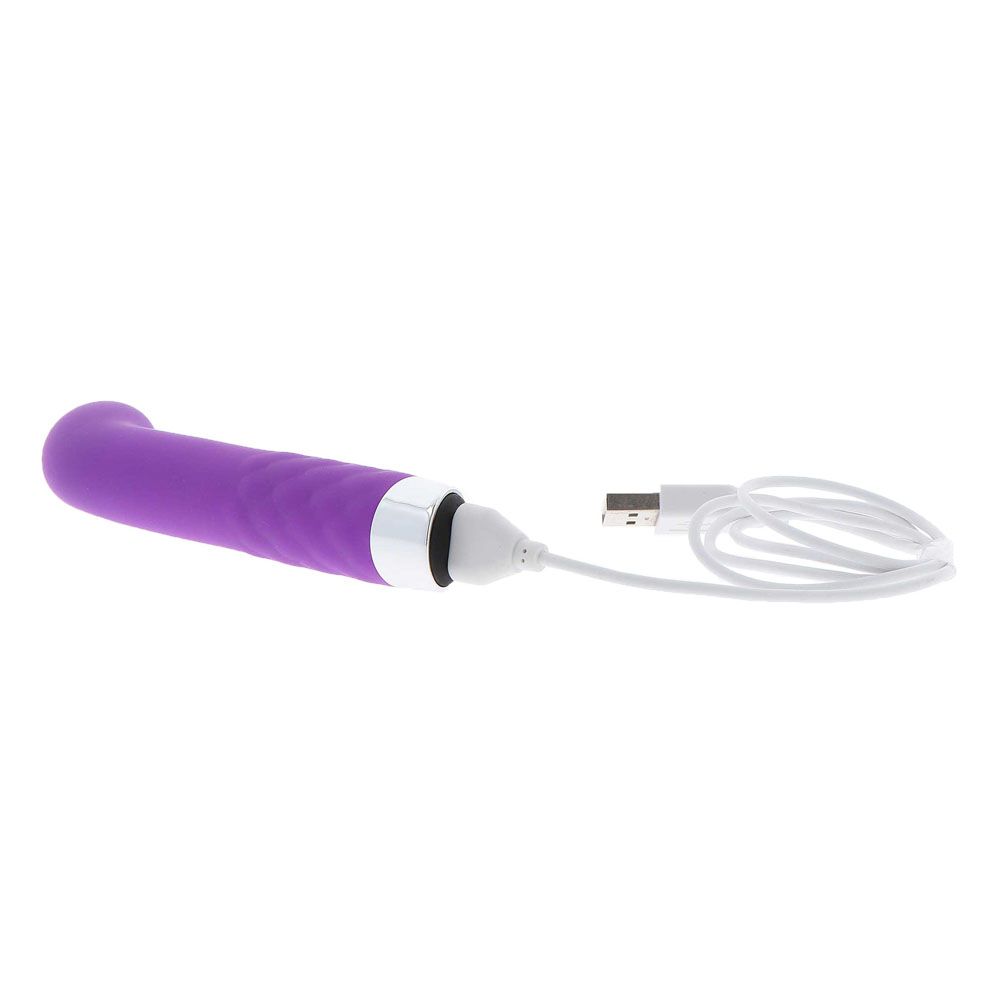 Purple personal care device with USB cable on white background