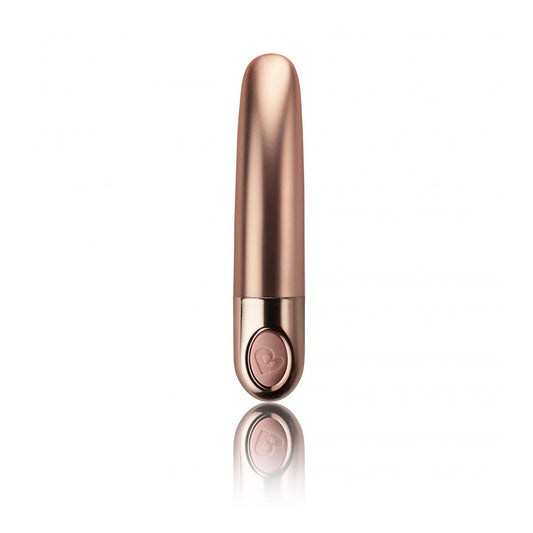 A dusk pink, ellipse-shaped mini vibrator with a smooth velvet finish and a tapered tip, shown against a reflective background.
