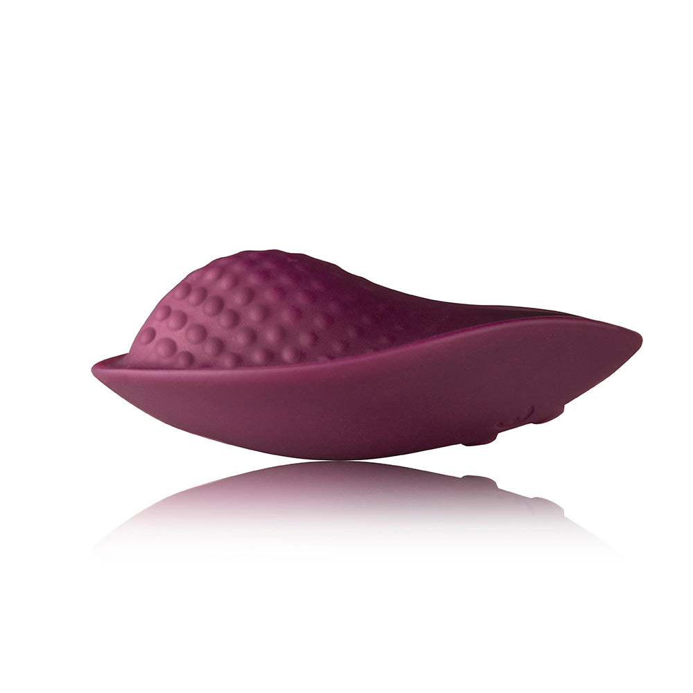 Purple silicone massager on a white background