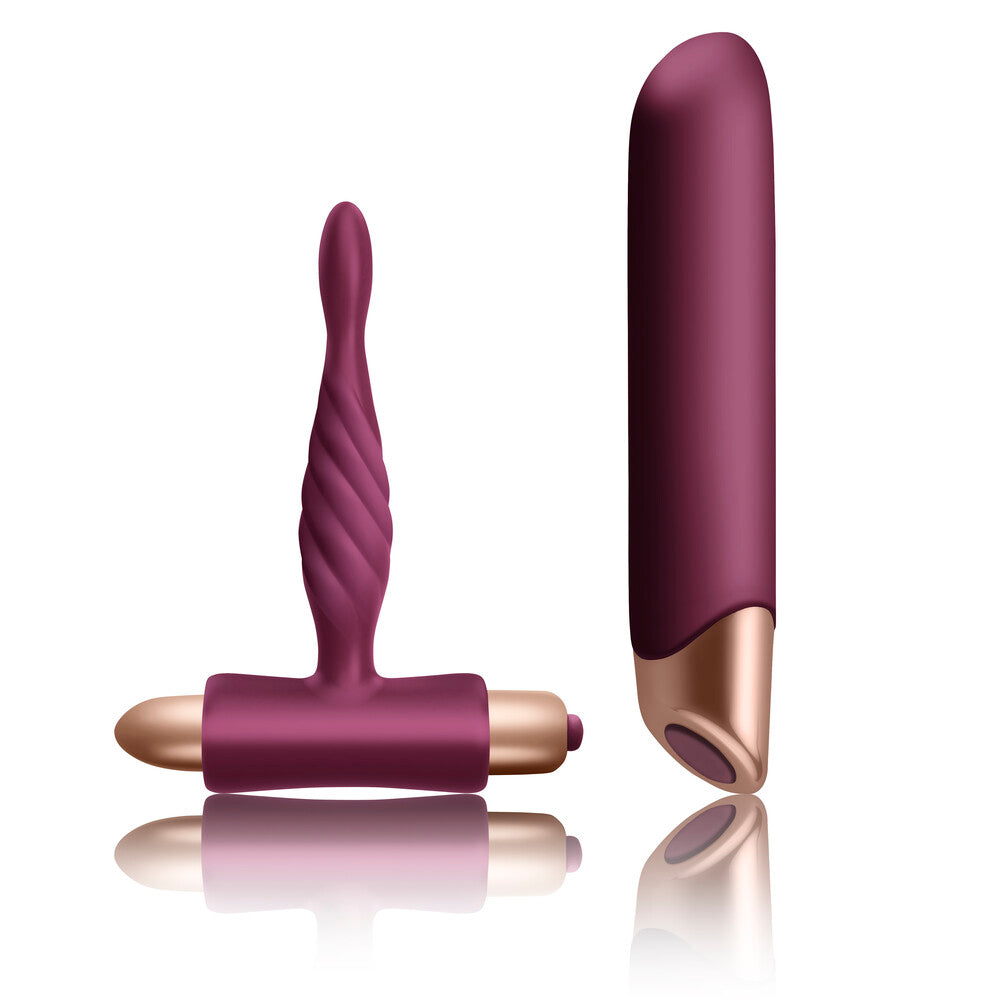 The image shows two maroon-colored silicone vibrators, one designed for vaginal insertion and the other for clitoral stimulation, along with their remote controls.