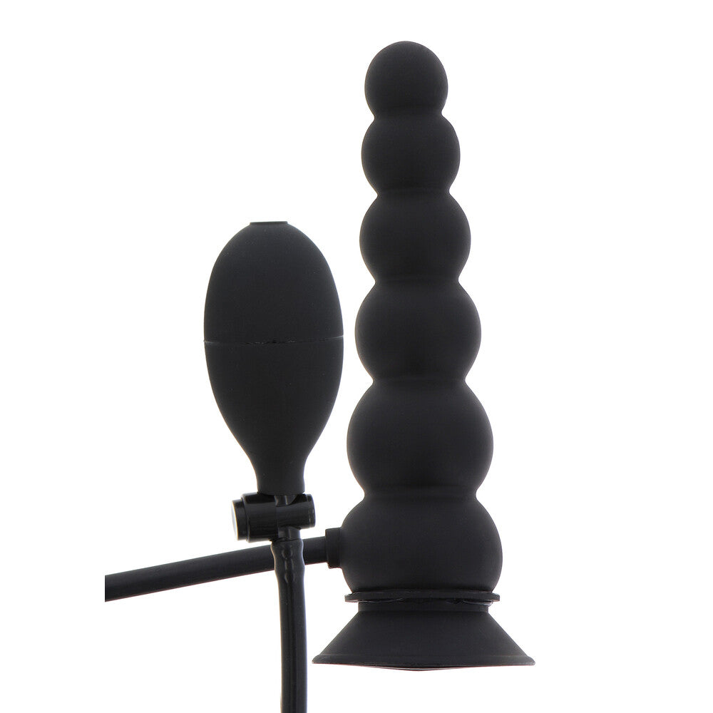 Black silicone butt plug with suction cup on a white background