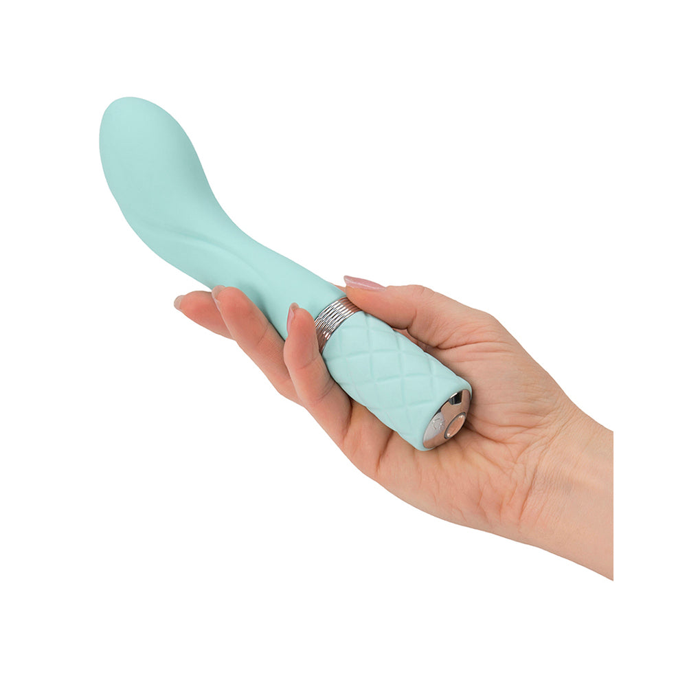 A light green, curved G-spot vibrator with a quilted handle and a crystal button.