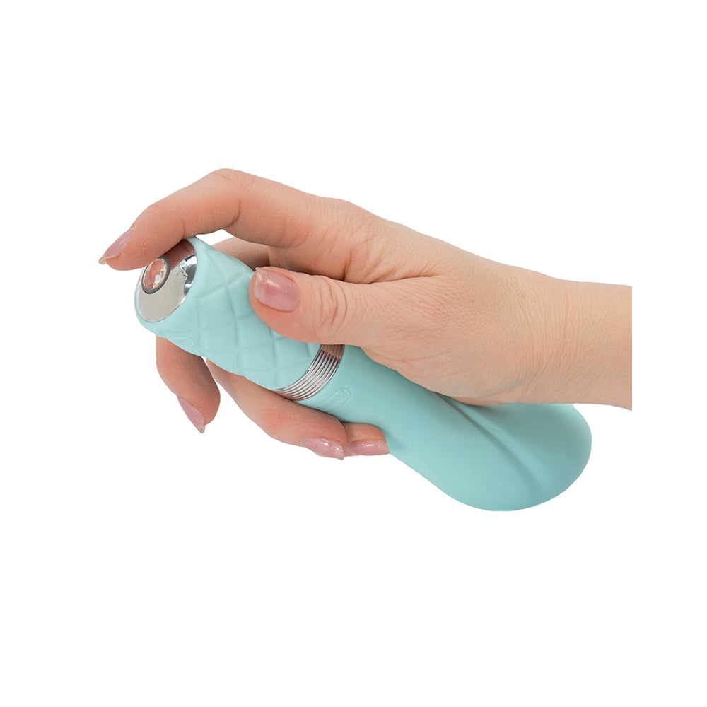 A light green, curved G-spot vibrator with a quilted handle and a crystal button.