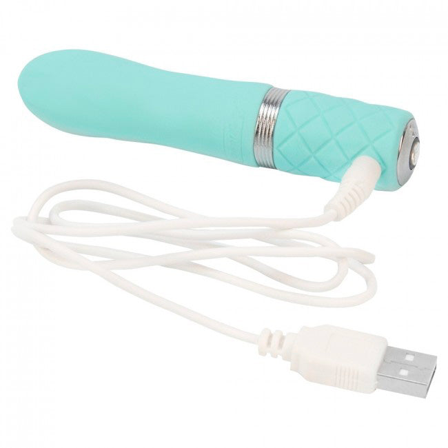 A small, teal-colored rechargeable bullet vibrator with a quilted handle and a metallic band near the base. It has a smooth, rounded tip and a Swarovski crystal button detail.