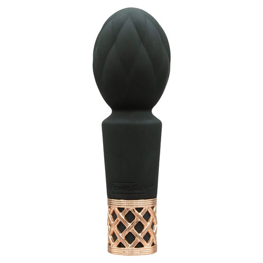 A hand holding a small, black Pillow Talk mini massager with a velvety silicone head and a rose gold-colored base.
