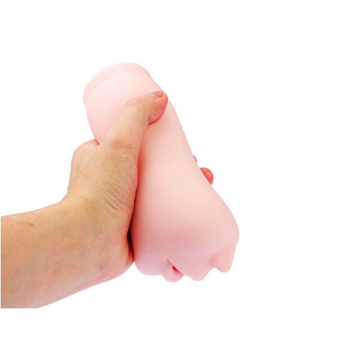 Pink silicone breast model held between hands on a white background