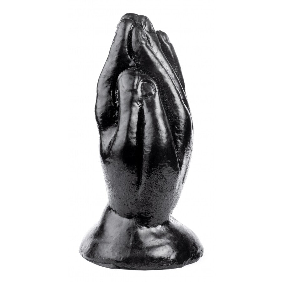 Black metal sculpture of praying hands on a white background