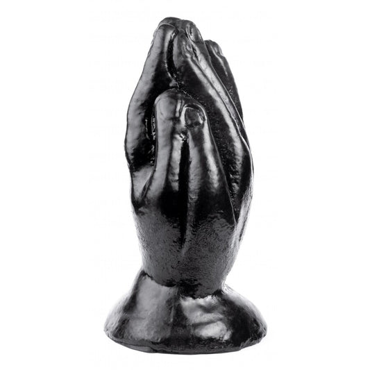 Black metal sculpture of praying hands on a white background