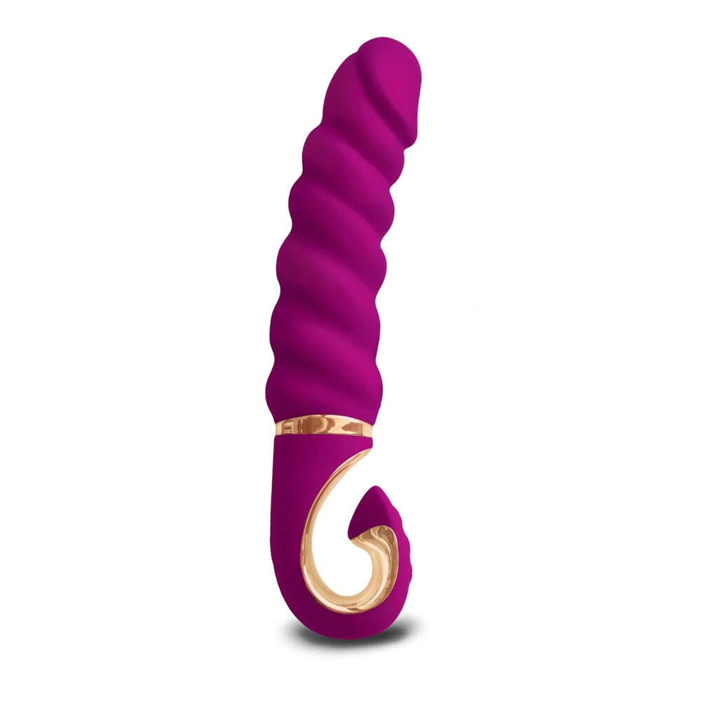 A purple, cylindrical mini vibrator with a curved end, featuring a thick, ridged design and a gold accent ring near the base.