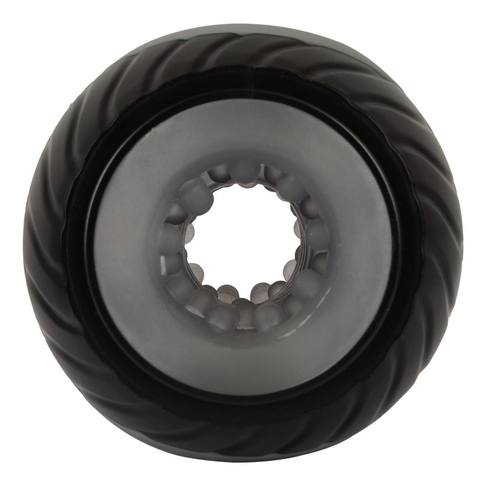 A gray, donut-shaped masturbator with a textured interior, featuring a power button on the side and an open design at both ends.