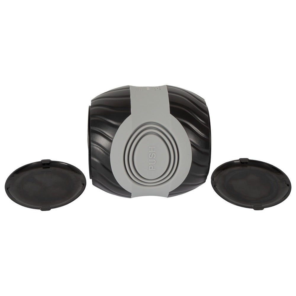 A gray, donut-shaped masturbator with a textured interior, featuring a power button on the side and an open design at both ends.