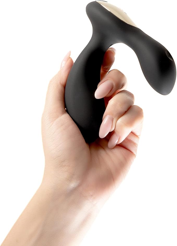 Hand holding a black and beige handheld device against a white background