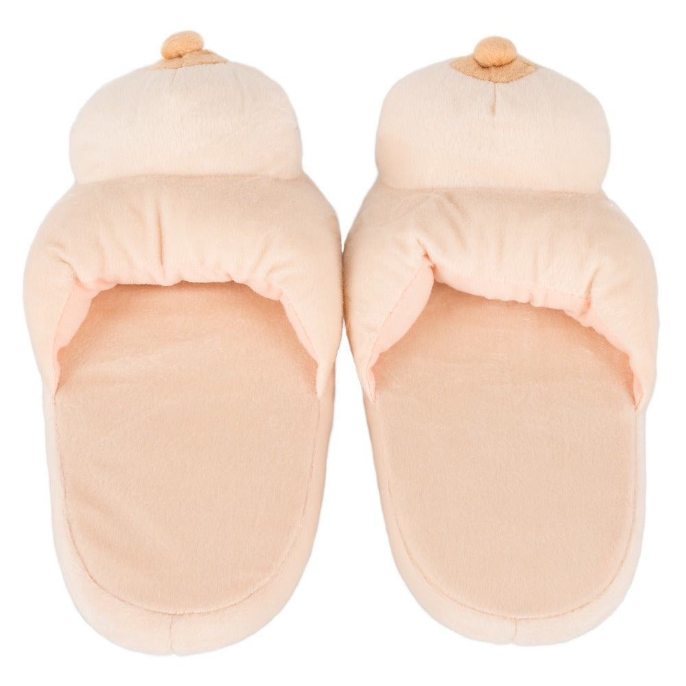 A pair of flesh pink boob-shaped slippers made from polyester.