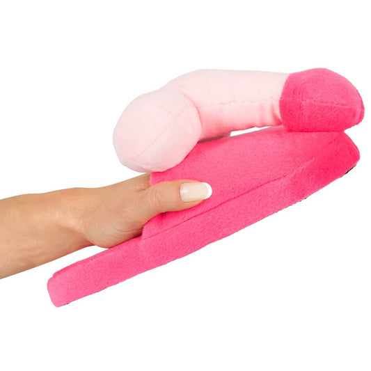 A pair of bright pink slippers with a penis-shaped design on the front.
