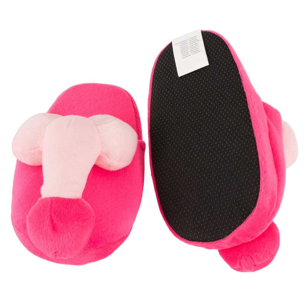 A pair of bright pink slippers with a penis-shaped design on the front.
