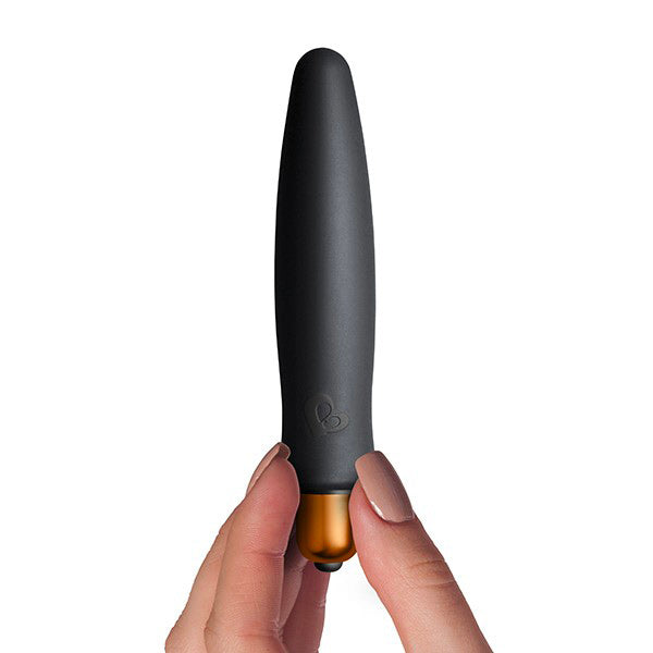 The image shows three black sexual wellness products. From left to right, there is a small cylindrical vibrator, a silicone bunny-shaped vibrator, and a larger, sleeker vibrator.