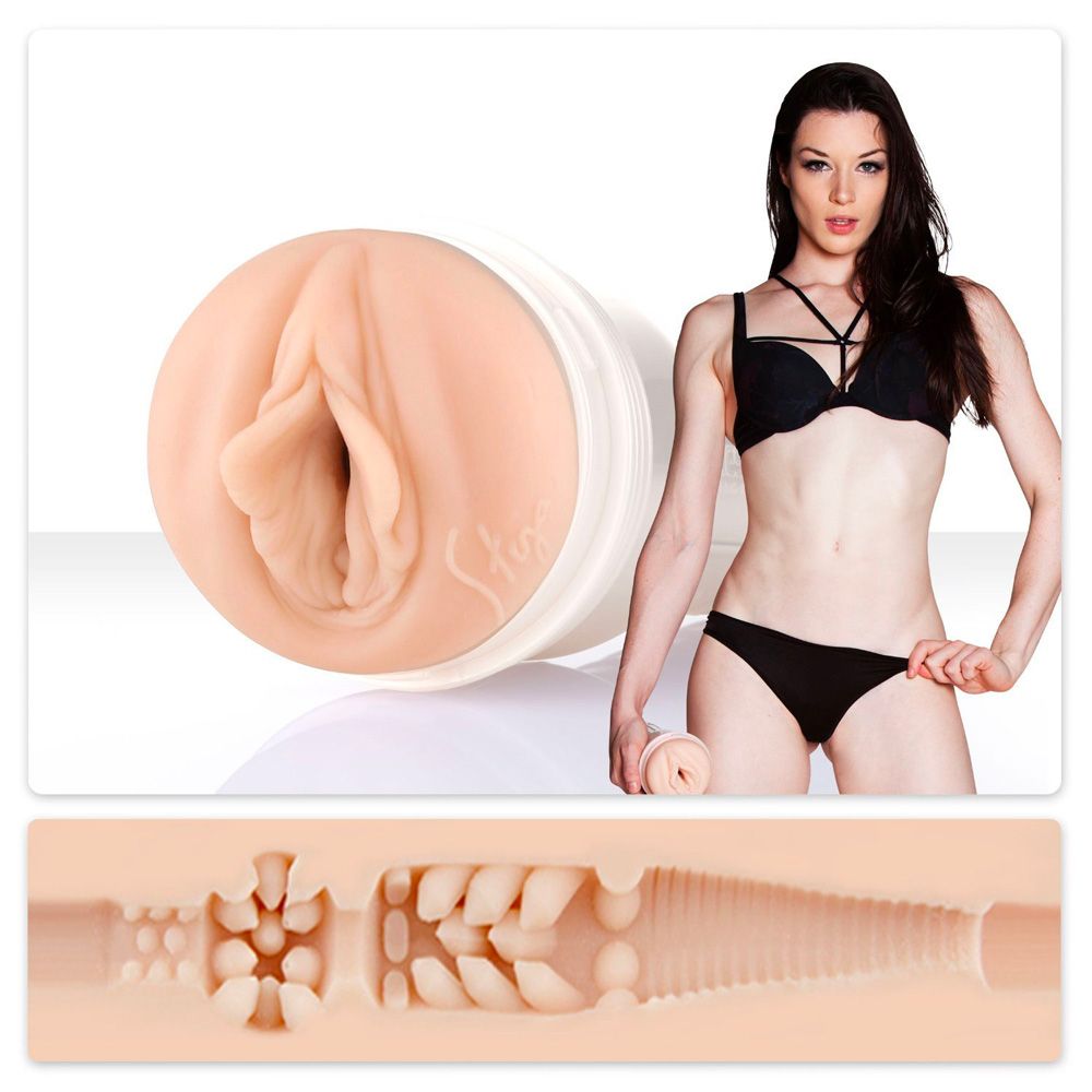 The image shows a product called the Stoya Destroya Fleshlight Girls Masturbator, which is a cylindrical device with a realistic flesh pink texture. There is also a photo of a woman in a black bikini, presumably the person whose body the product was modeled after.