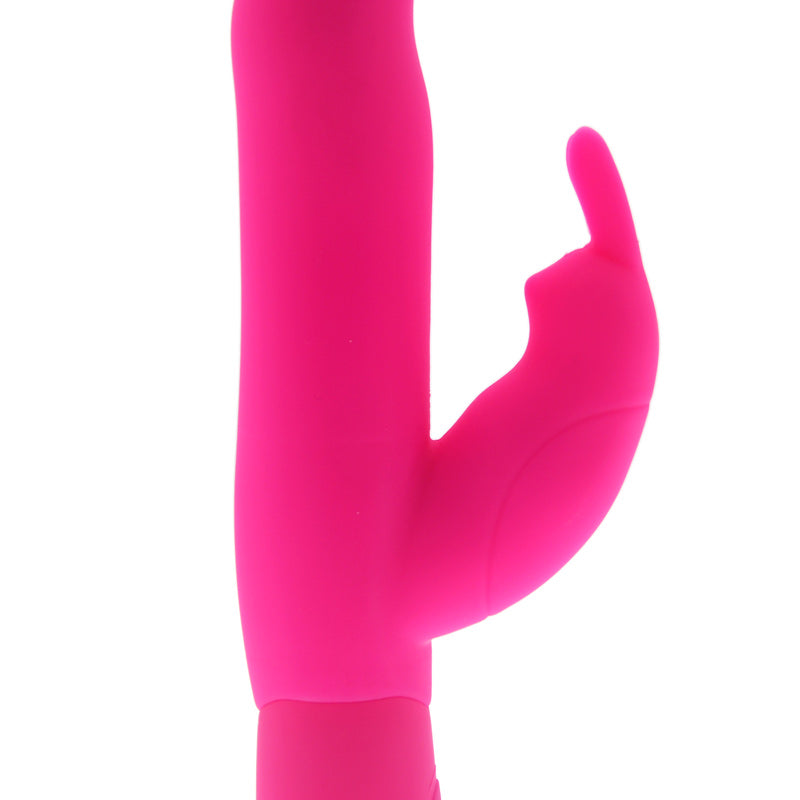 A pink Joy Rabbit Vibrator with a slender shaft and a realistic tip. It has a rabbit-style clitoral stimulator with soft, fluttering ears and control buttons on the base.