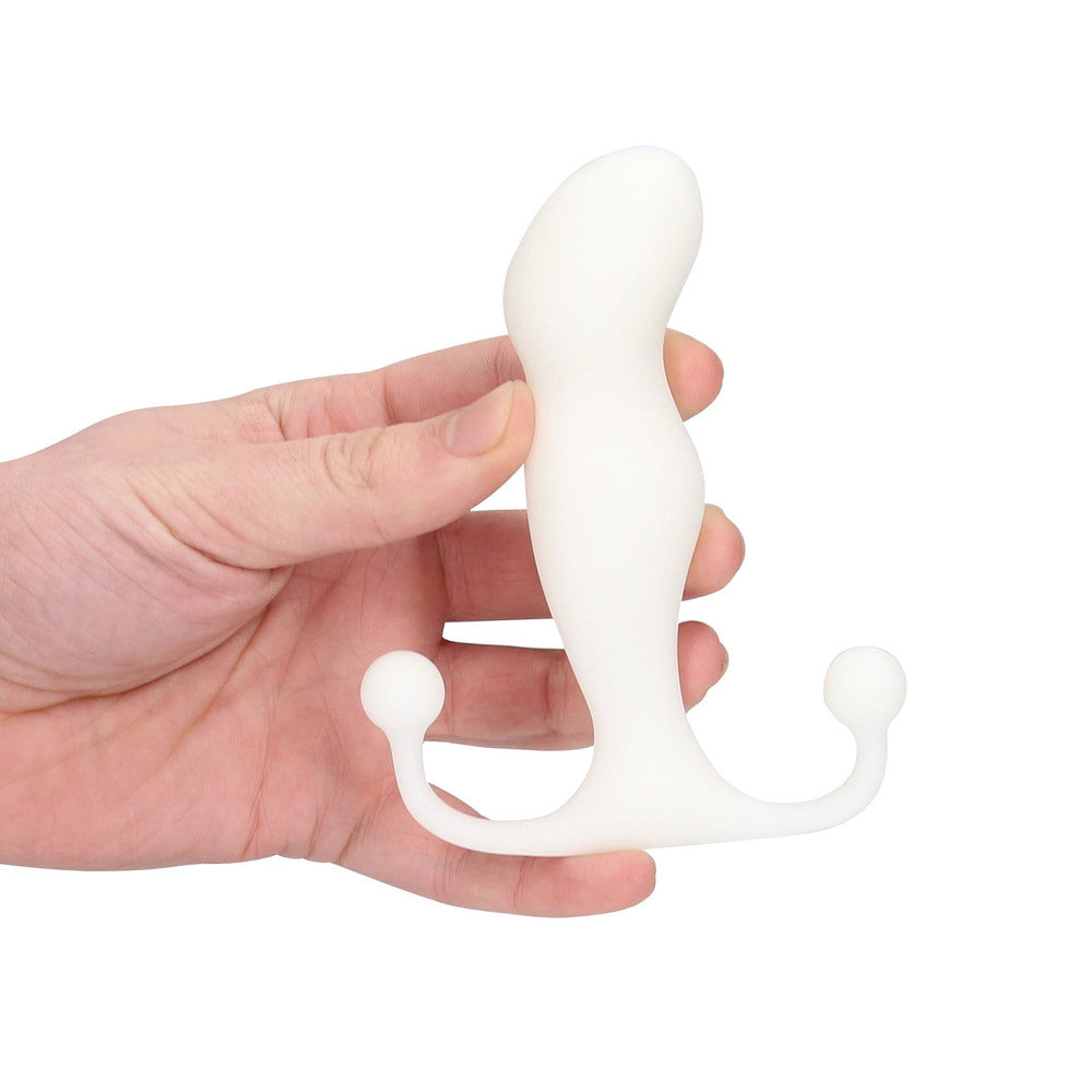 White plastic tool held in a hand against a white background