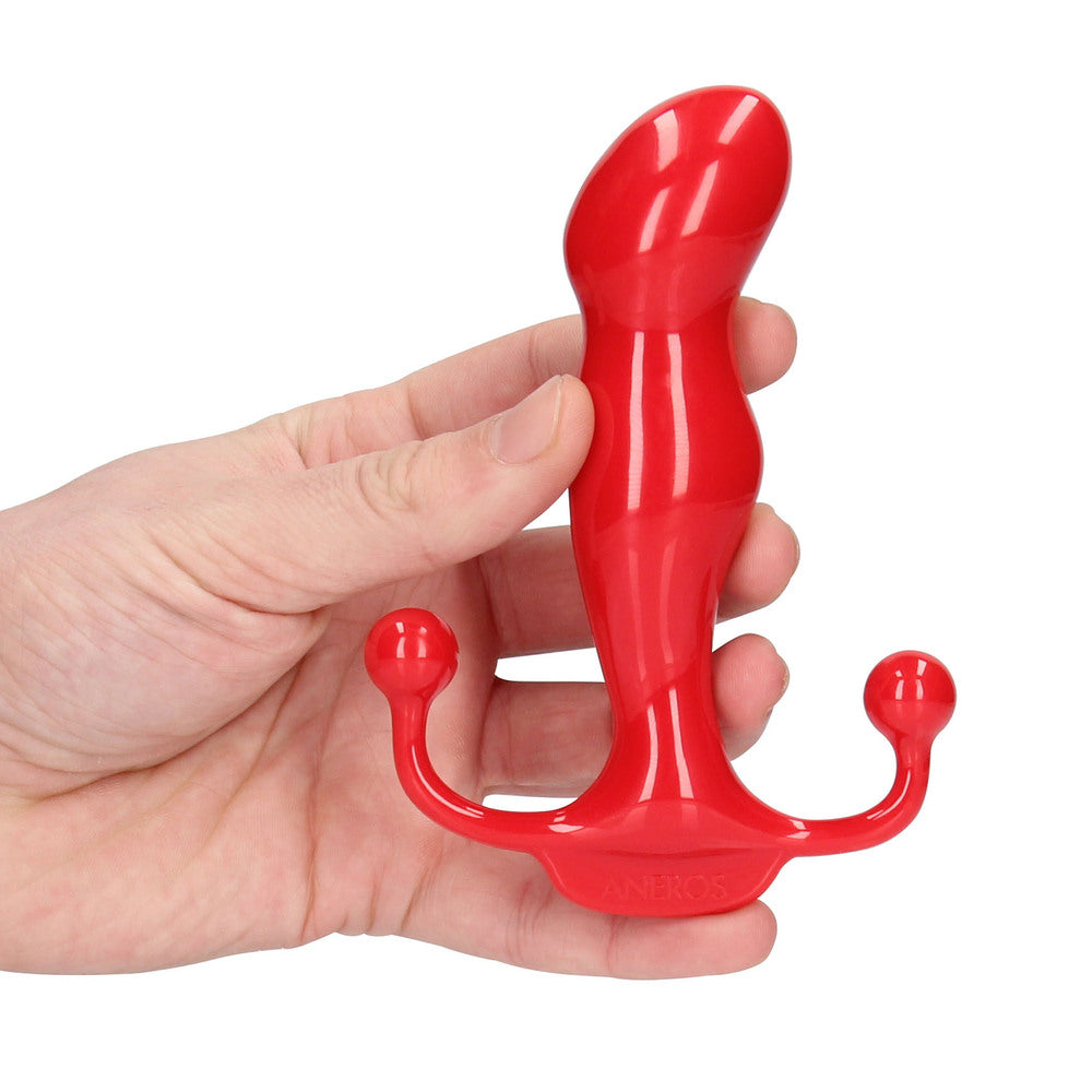 Red plastic tool held in a hand against a white background