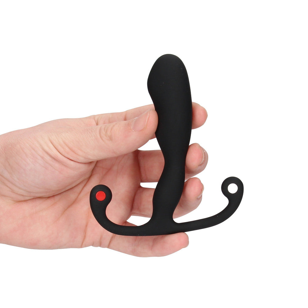 Black plastic tool held in a hand on a white background