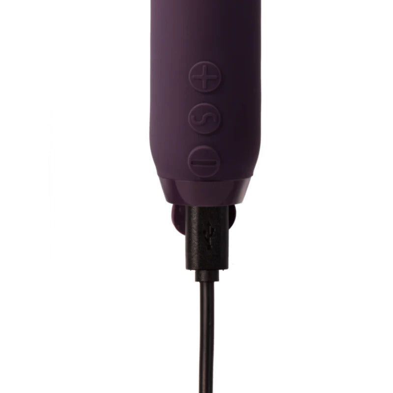 A purple, bullet-shaped vibrator with a textured, multi-surfaced tip and control buttons near the base.