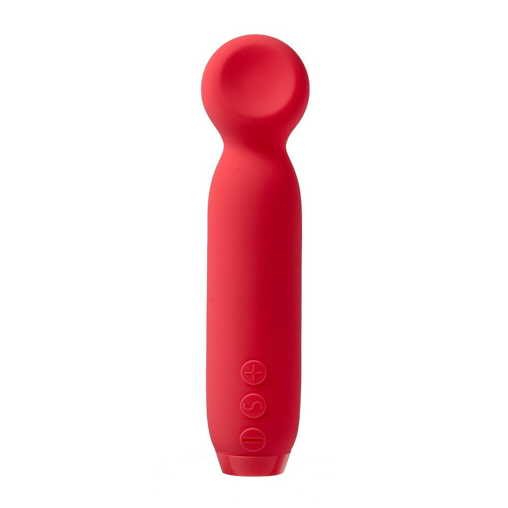 A hand holding a red, bullet-shaped vibrator with a smooth, rounded tip.