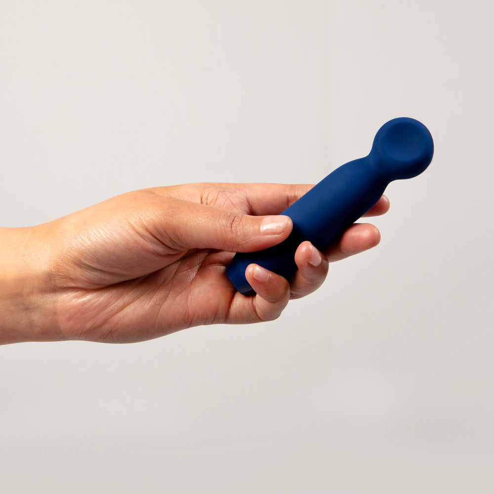 A navy blue, sleek and modern bullet vibrator with a rounded tip and a built-in control panel.