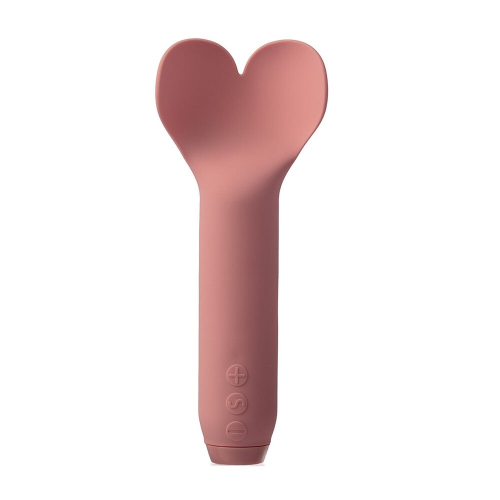 A hand holding a pink, heart-shaped bullet vibrator.