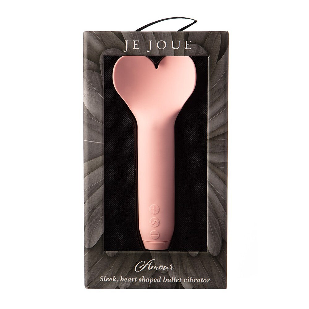 A hand holding a pink, heart-shaped bullet vibrator.