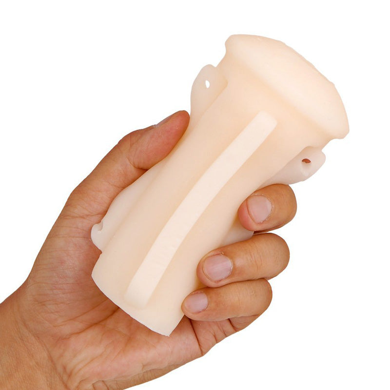 Hand holding a cylindrical cream or soap bar against a plain background