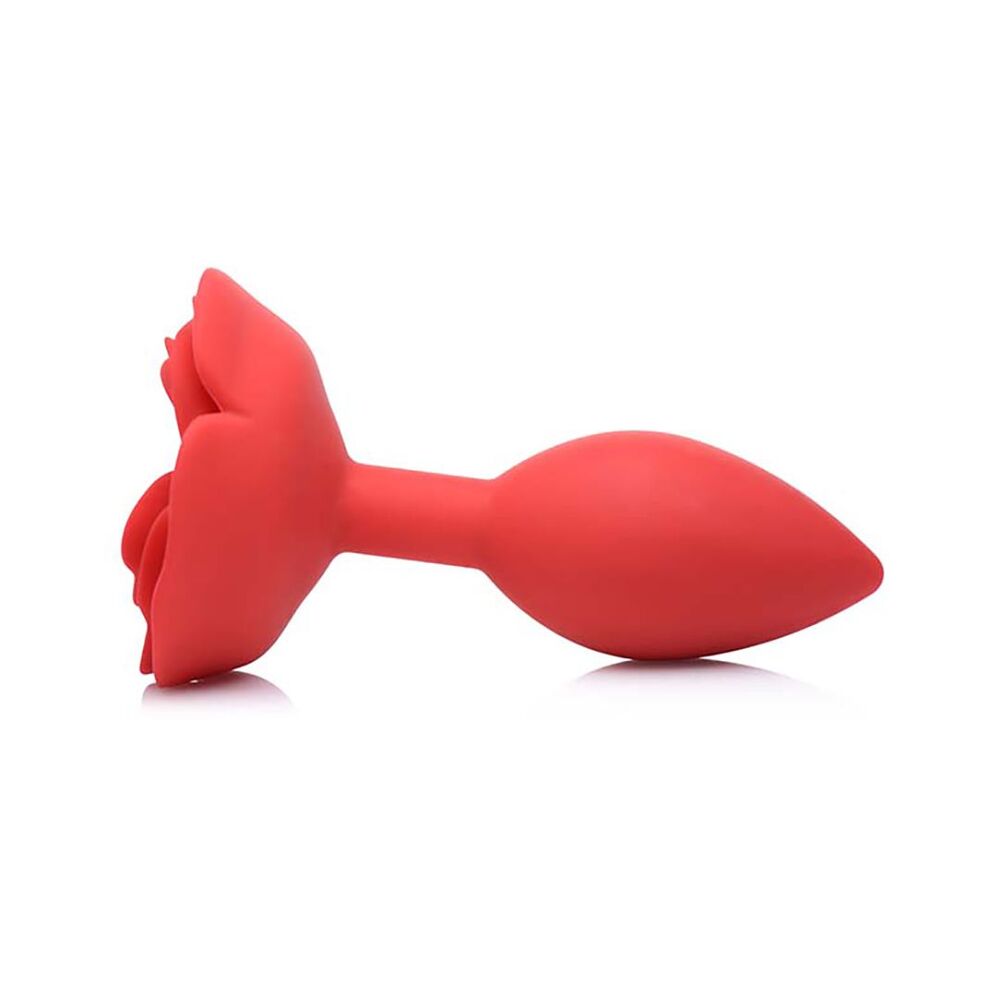 Red silicone butt plug on a white background