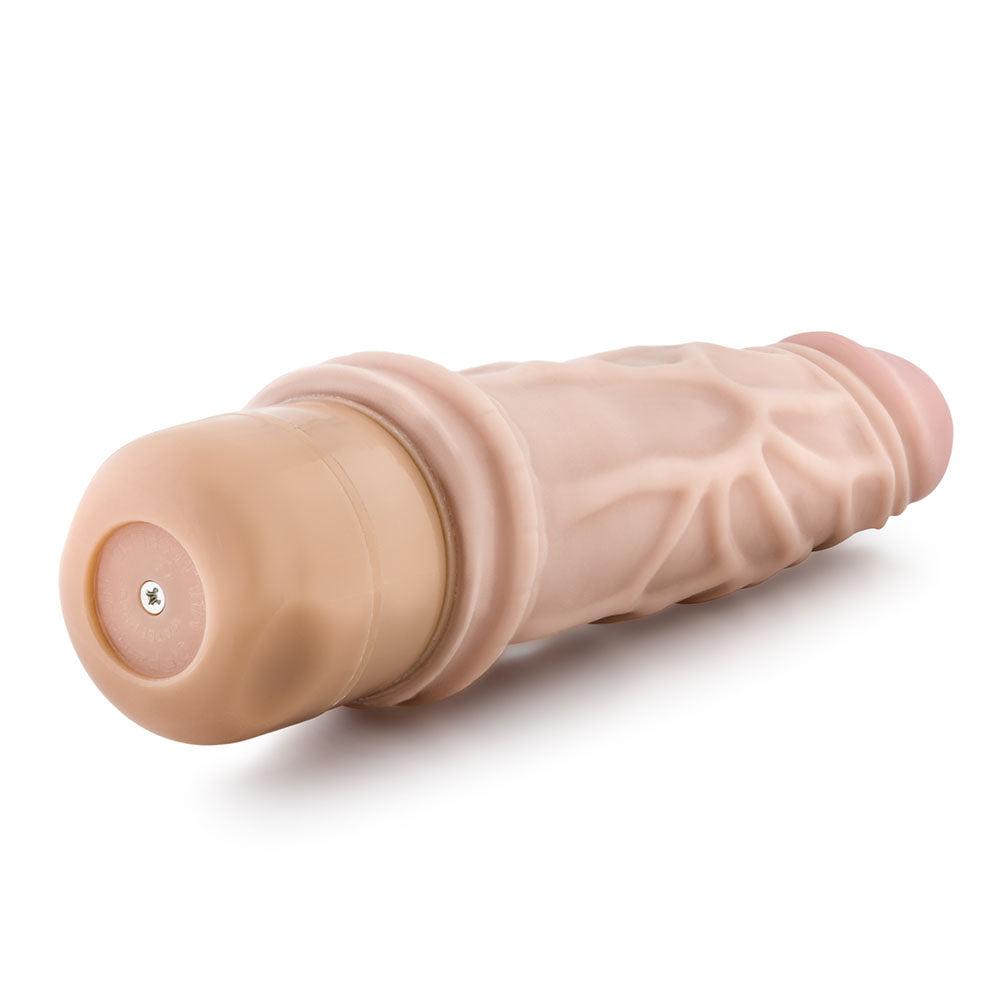 A flesh-colored, realistic vibrator with a twist dial base, featuring veins along its length.