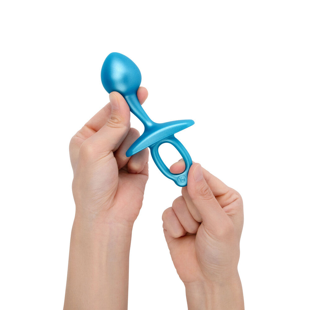 Blue baby rattle held by a person's hands on a white background