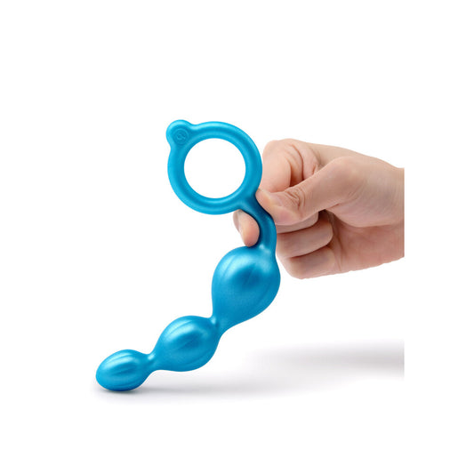 Blue plastic tool held by a hand on a white background