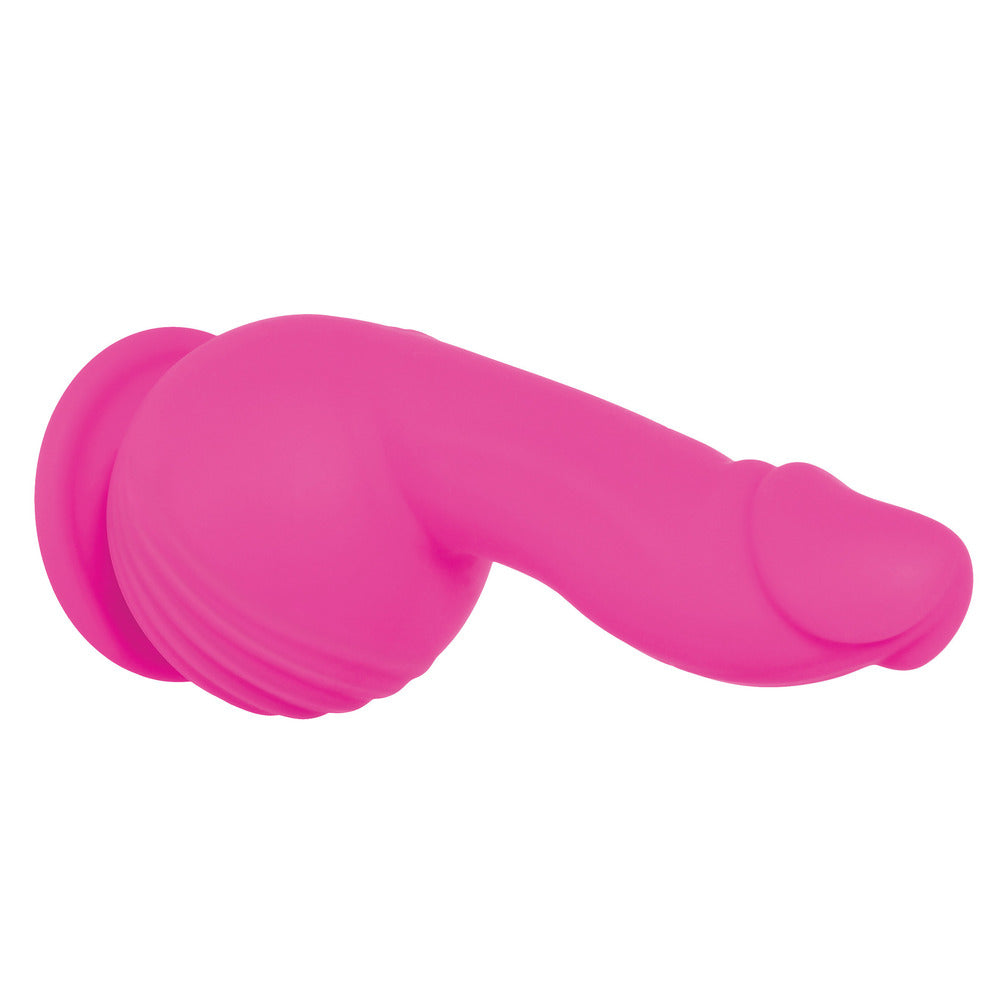 Pink silicone adult product on a white background