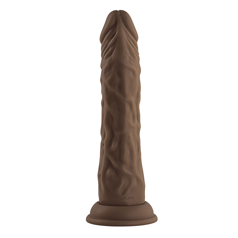 A brown, realistic-looking penis vibrator with a wireless remote control. The vibrator shows detailed textures and a realistic design, while the remote control is simple with a few buttons.