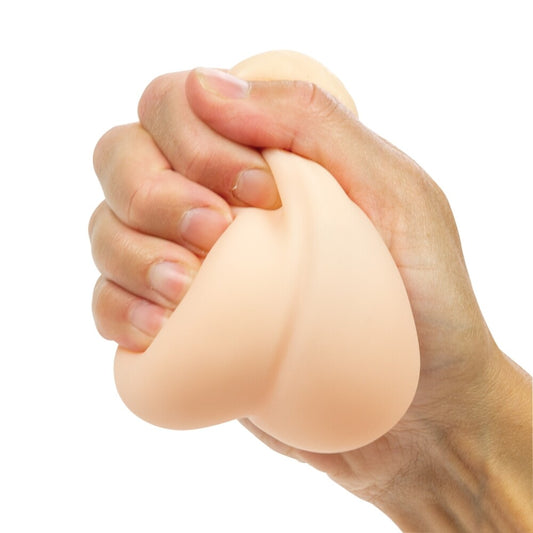 A hand holding a beige, testicle-shaped stress reliever.