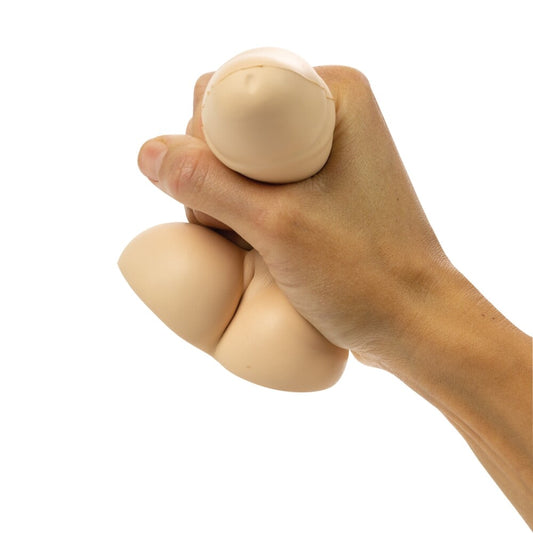 A hand holding a beige stress relief toy designed to look like a walnut.