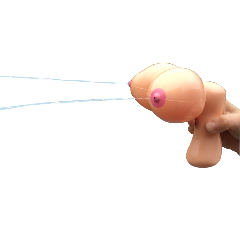 A flesh pink water pistol designed to look like breasts, with each nipple serving as a separate nozzle. The gun has a simplistic, cartoon-like appearance.