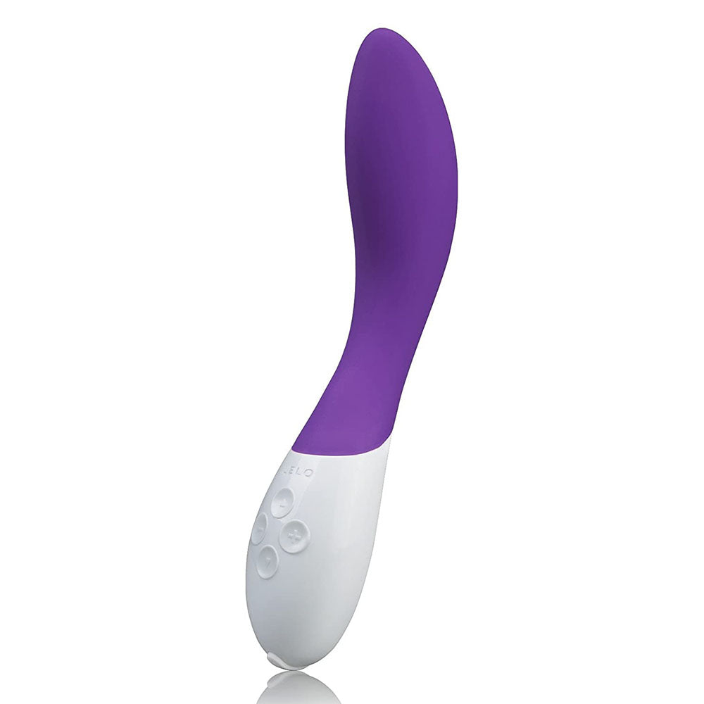 A purple and white Lelo Mona 2 G-Spot vibrator with a sleek, curved design and a white base with buttons.