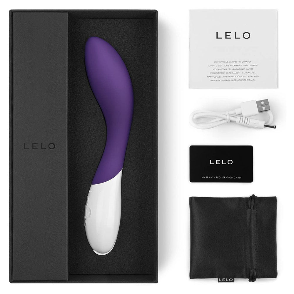 Purple and white electronic device in a black box with Lelo branding, including a cable and warranty card.