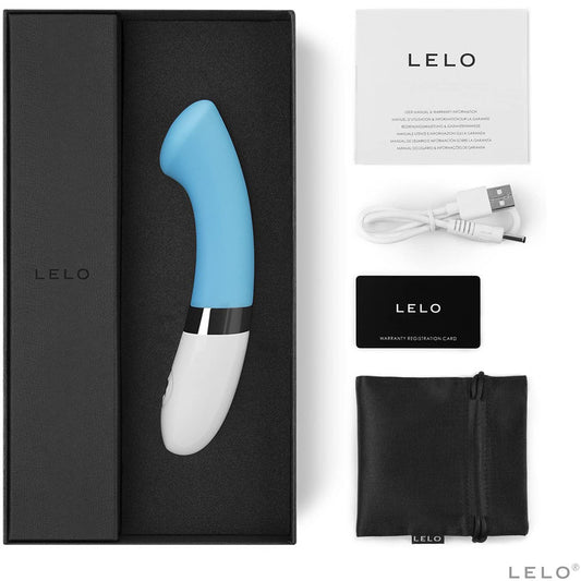 A turquoise blue G-spot vibrator with a sleek, smooth design and a white base. The device has a flattened tip and a curved handle, with a power button and an interface dial on the white stem.