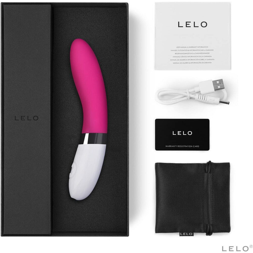 Pink and white Lelo product with packaging, USB cable, and warranty card on a white background
