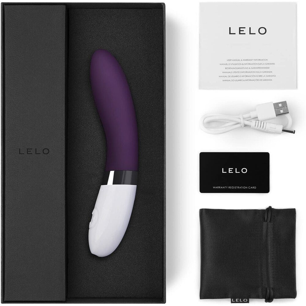 Purple and white Lelo product with packaging, USB cable, and warranty card on a white background