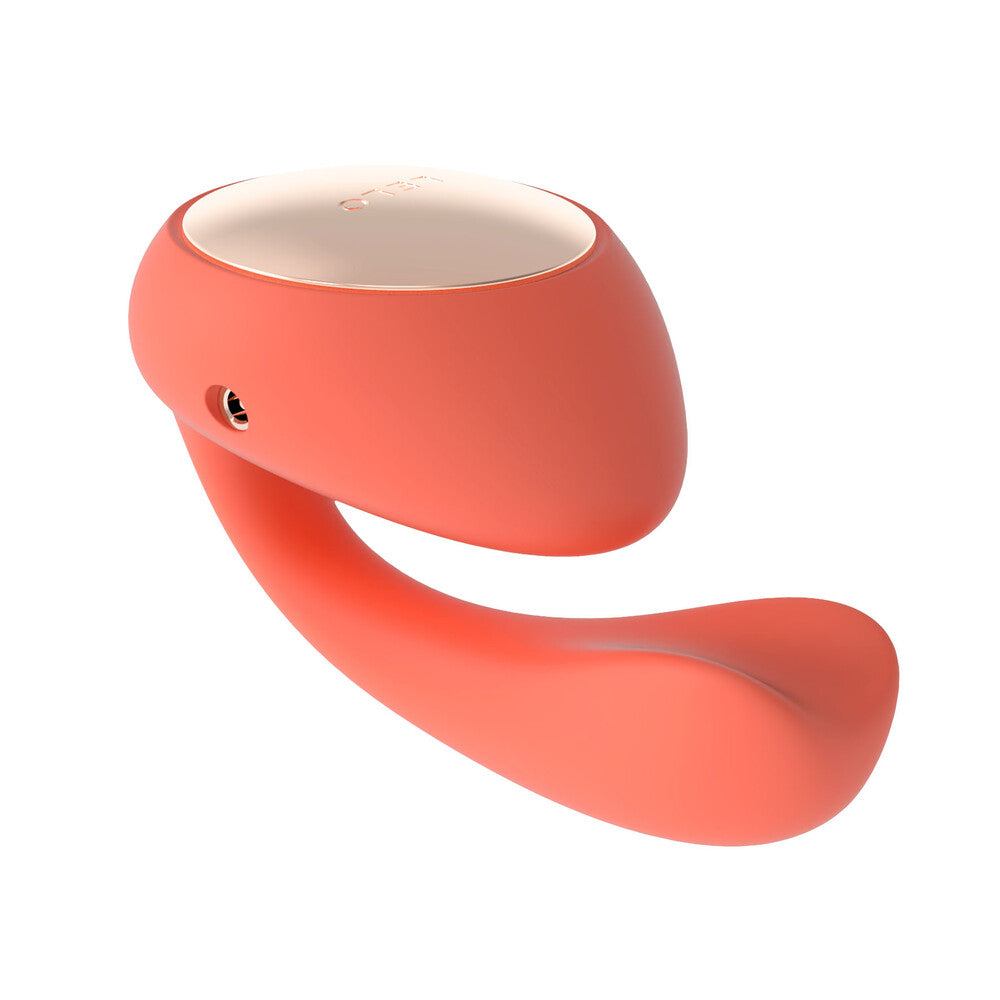 A coral-colored dual vibrator with a sleek, ergonomic design featuring a larger tip and a rotating, insertable tail.