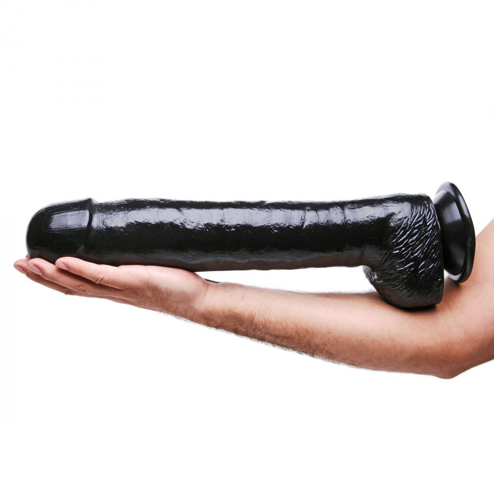 Black rubber product held in a hand against a white background