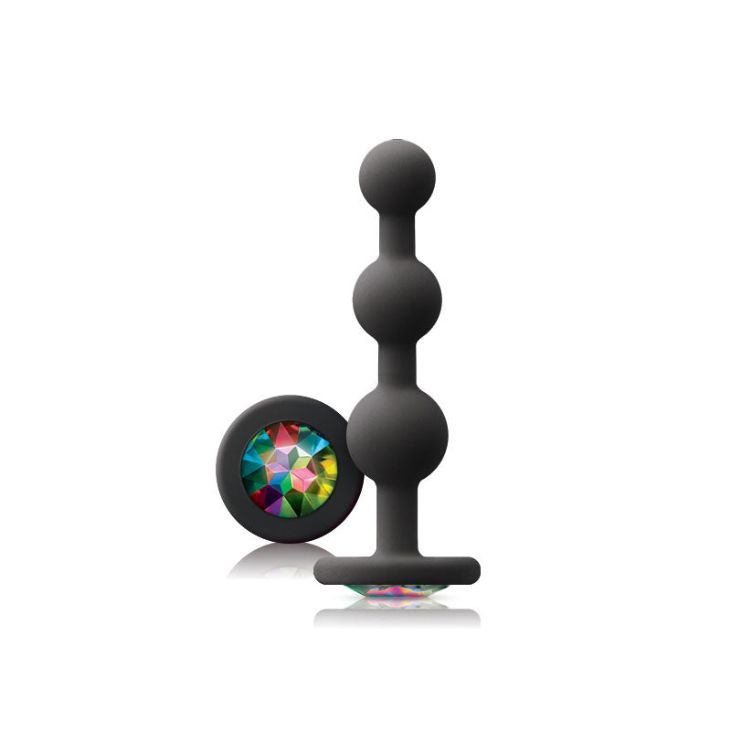 Black silicone butt plug with colorful gem on a white background