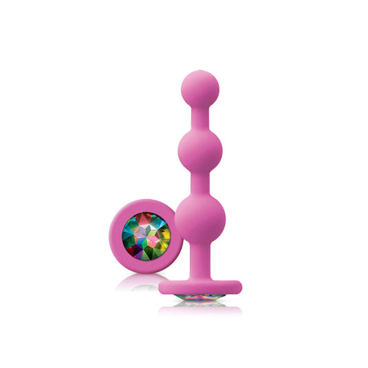 Pink toy with a colorful gem on a white background
